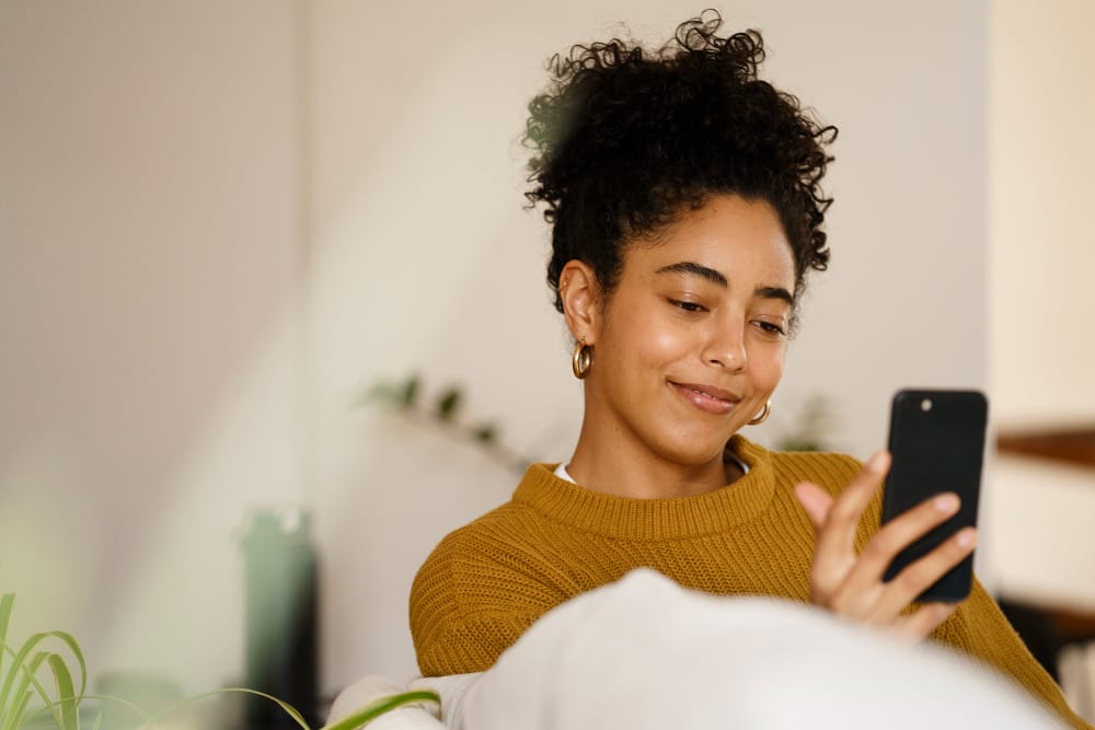 Smiling woman looking at smartphone representing hassle-free free cancellation